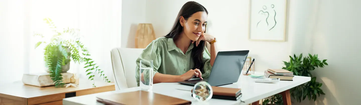 woman sitting at her home office desk