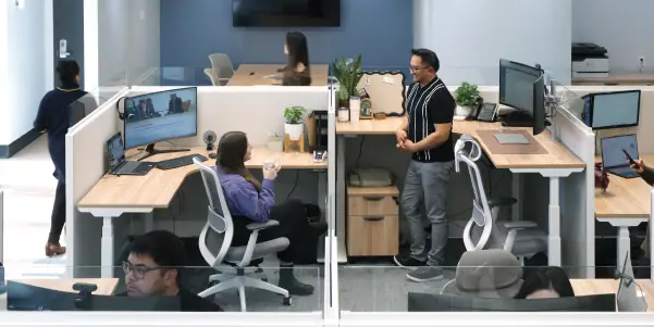 man and woman having a meeting while walking in the office