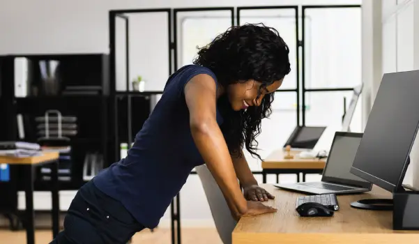 woman doing a pushup at her desk