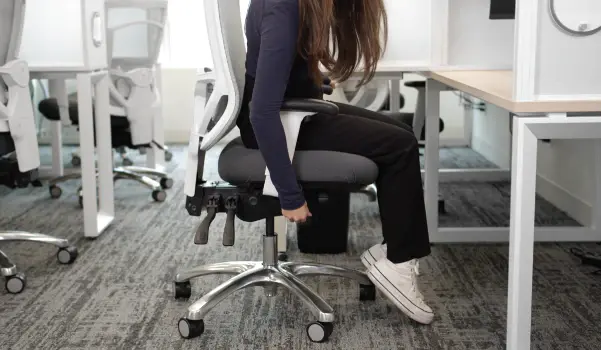woman adjusting her ergonomic chair