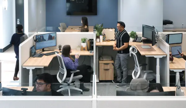 a lively office with coworkers chatting and walking around