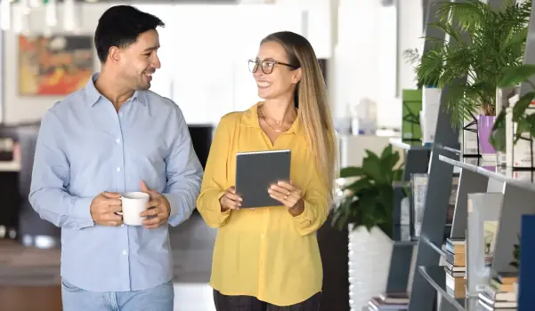 man and woman having a meeting while walking in the office